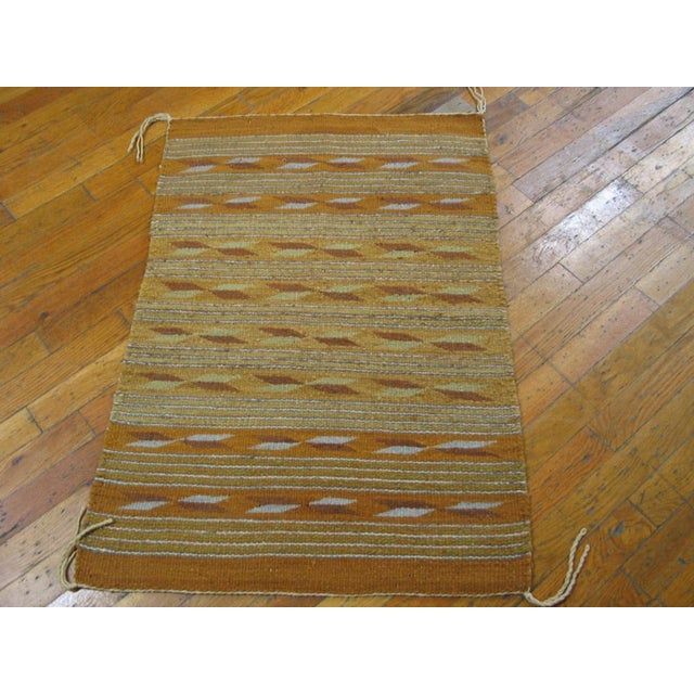 Antique Navajo American Brown 1940s Rug, Circa Date: 1940s. This exceptional piece of Americana weaving represents the...
