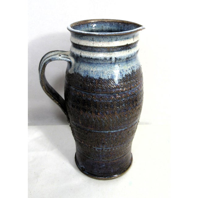 This charming piece is utilitarian pottery art. It is beautiful and functional. It is food safe with glazed interior....
