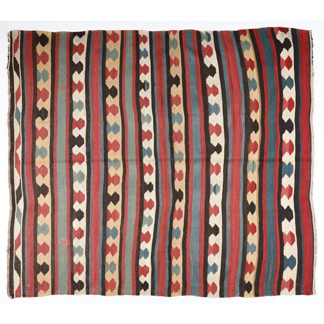This handwoven Shirvan Kazak kilim is a remarkable example of Caucasian textile artistry from the late 19th to early 20th...