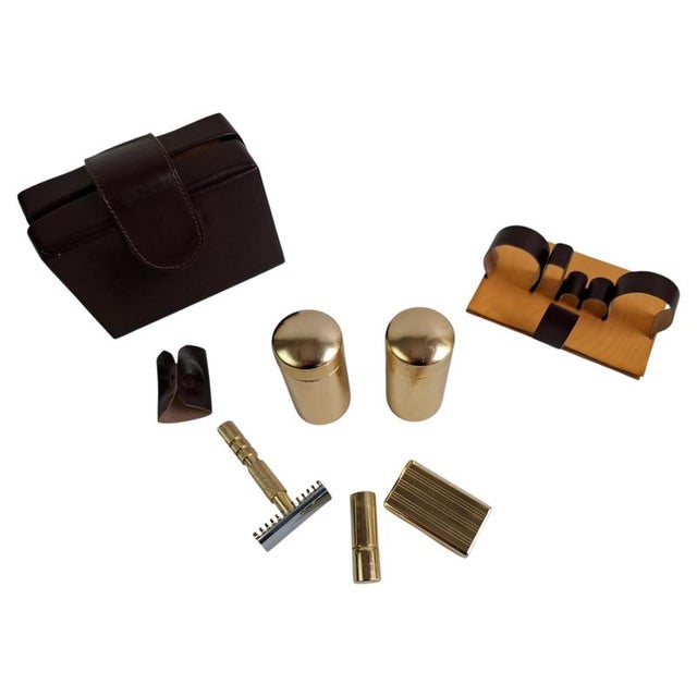An elegant French Mid-Century Modern travel shaving kit manufactured circa 1960, presented in its original brown...