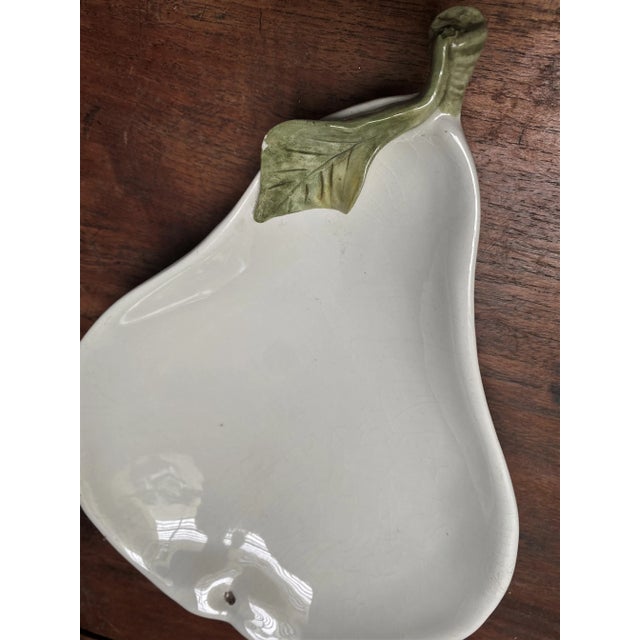 This is a fun large (13 inches X 9 1/2 inches X 2 inches) white pear shaped shallow bowl with a single green raised leaf...