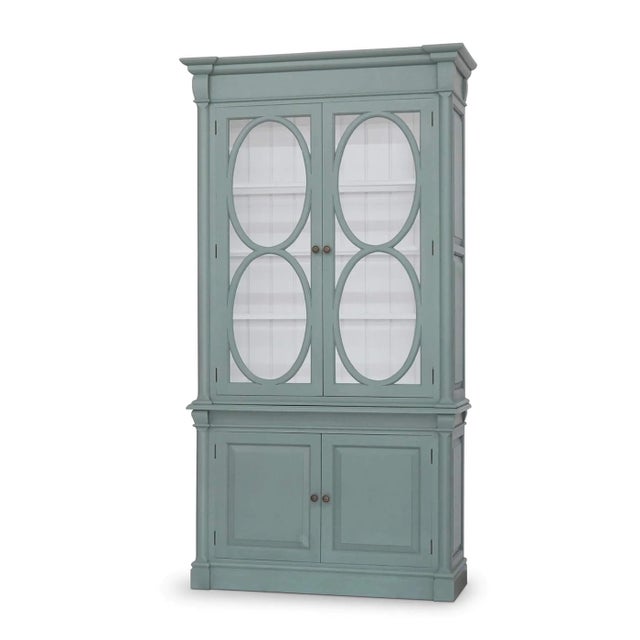 Finished in a soft Green Smoke paint, its exterior evokes the elegance of antique French cabinetry, while the True White...