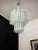 ELECTRICAL SYSTEM ADAPTED FOR US/AU/EU Italian glass chandelier with albaster white glass tubes. The armor polished nickel...