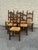 Set of six vintage Italian dining chairs featuring tall carved wood frames with decorative pierced backs and woven rush...