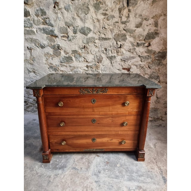 Elegant antique chest of drawers dating from approximately 1820–1850, crafted from solid walnut and oak. Featuring a dark...