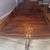 Large traditional mahogany extension dining table with two removable leaves. Features a highly polished figured-wood top...