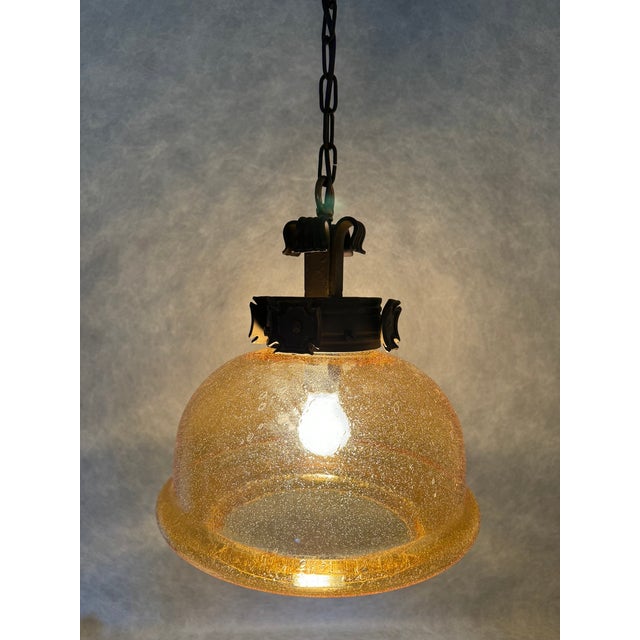 Original German interwar pendant lamp manufactured by Koch & Söhne. The heavy hemispherical pressed glass shade with...