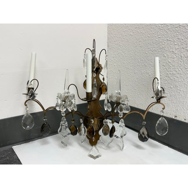 Design Plus Gallery presents a Vintage Hollywood Regency Crystal Prism Five-Light Wall Sconce. This ornate electric...