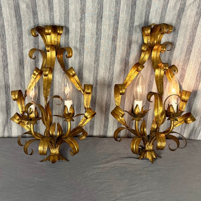 Fabulous pair of Mid-Century Hollywood Regency Style Italian Gold Leaf Sconces likely made in the 30s or 40s. They have...