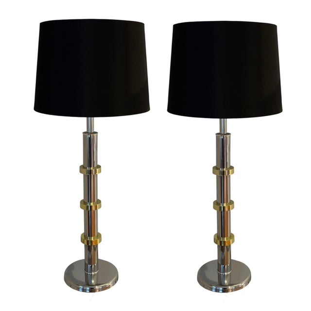 This is a pair of large chromed-steel and brass table lamps, dating to the 1970s. The black drum lampshades are new and...