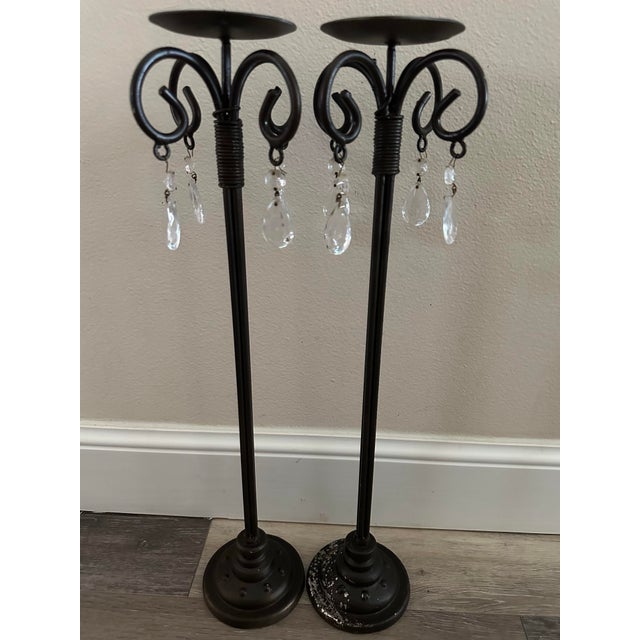 Very dark bronze colored candle holders with scroll design and dangling crystal like accent pieces. Each measures 5 1/2” x...