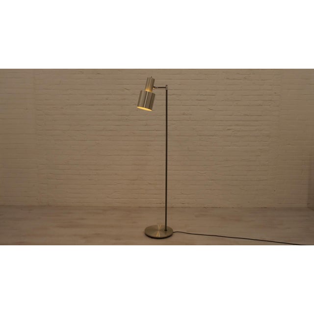 This vintage lamp is a design called 'Studio' by Jo Hammerborg for Fog & Morup. The floor lamp has a chrome shade and base...