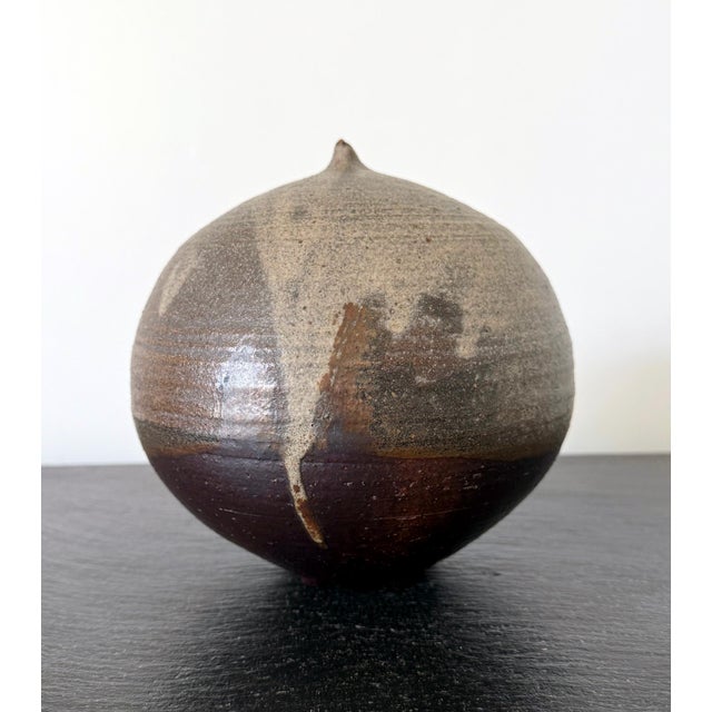 A ceramic closed-form pot with rattle by Japanese American artist Toshiko Takaezu (American, 1922 - 2011) circa 1980s. The...