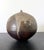 A ceramic closed-form pot with rattle by Japanese American artist Toshiko Takaezu (American, 1922 - 2011) circa 1980s. The...