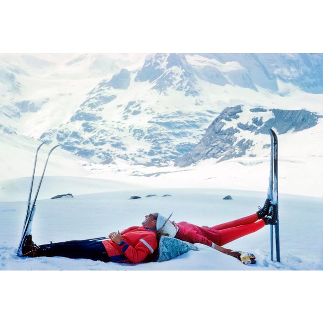 Ski Mirror by Toni Frissell Two skiers lie back to back at the top of a mountain in Zermatt, Switzerland, 1961. (Photo by...