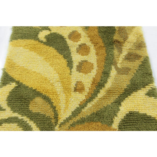 Hand-knotted in lush, high-pile wool in Sweden circa 1960-1970, this 3x5 vintage Swedish Rya rug is a bold new addition to...