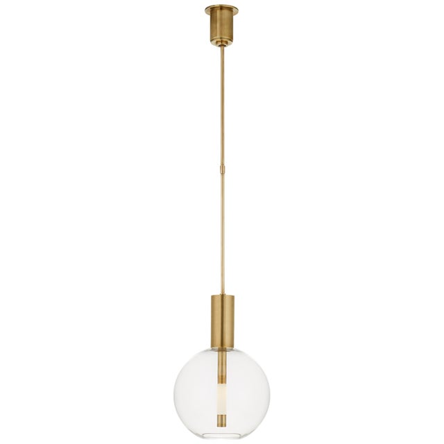 Nye Globe Pendant in Antique-Burnished Brass with Clear Glass Designer: Kelly Wearstler Fixture Height: 19.25" Min. Custom...