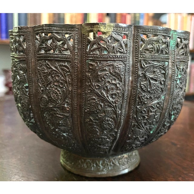 Antique Middle Eastern or Kashmiri pierced copper bowl, circa late 19th century. The hand-hammered bowl is highly detailed...