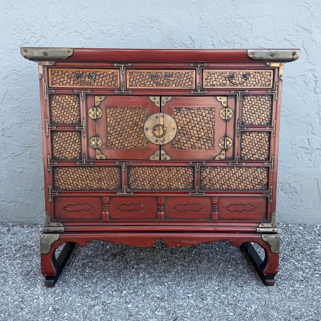 This vintage Chinese Tansu-style cabinet showcases the timeless craftsmanship of traditional Asian furniture with a richly...