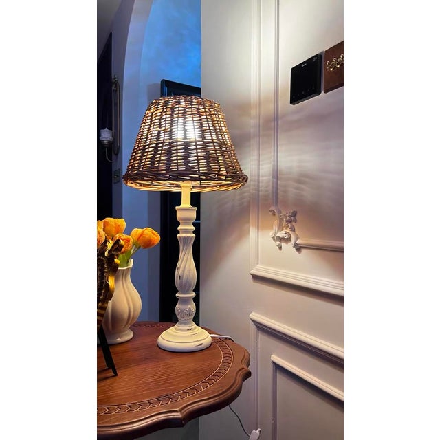 Shade is natural wood-colored rattan (natural texture, soft light transmission), body is distressed cream iron (carved...