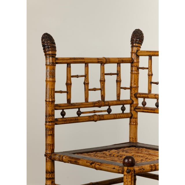 Late Victorian tortoiseshell bamboo armchair with carved acorn finials, bamboo ball details, geometric back splat, slatted...