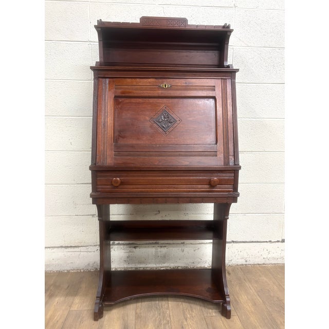 This is an absolutely stunning antique Victorian late 19th century (1800s) walnut drop front or drop lid Knapp joint...