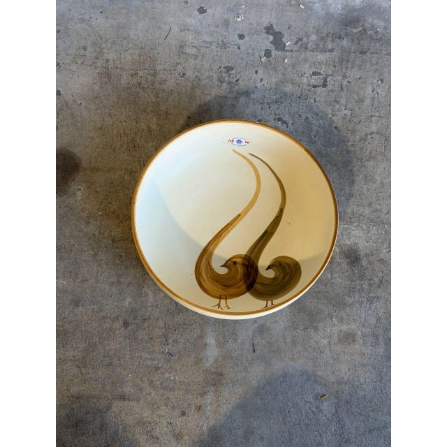 This stunning stoneware large serving bowl features a beautiful interior hand-painted design depicting stylized bird...