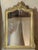 A beautifully gilded wall or pier mirror of elegant form, the graceful curves of the crest are complemented by the Rococo...
