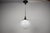 A Czechoslovak pendant lamp from the 1970s featuring an opaline glass globe suspended from a chrome-plated rod with black...