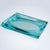 Turquoise glass bowl or centerpiece in a rectangular shape. The bowl is faceted on the outer edge and forms an oval with a...