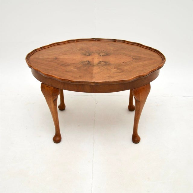 A good looking and very well made antique figured walnut pie crust coffee table. This was made in England, it dates from...