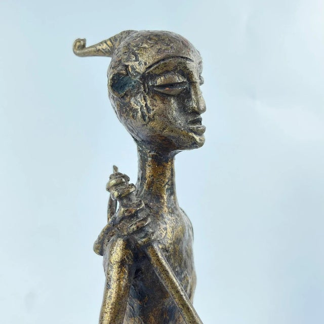 A beautifully cast brass Mossi hunter figure. Very elegant. The Mossi, the largest group in Burkina Faso, trace their...
