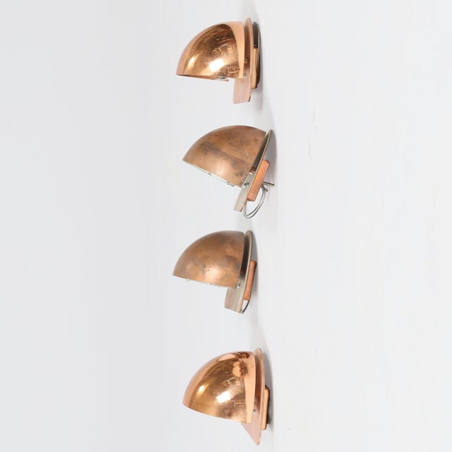 Small semicircular wall lamps made of patinated copper. Daro. Denmark. four semicircular wall lamps with patinated copper...