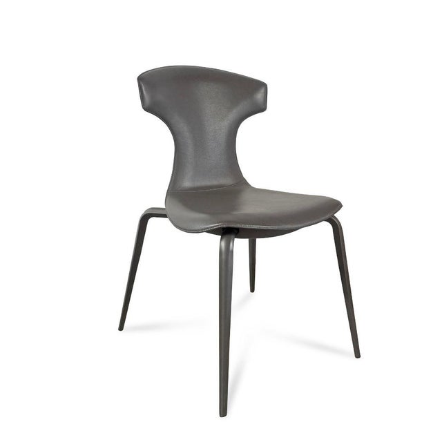 The Dining Chairs embody refined Italian craftsmanship with a distinctly modern edge. Upholstered in supple leather, each...
