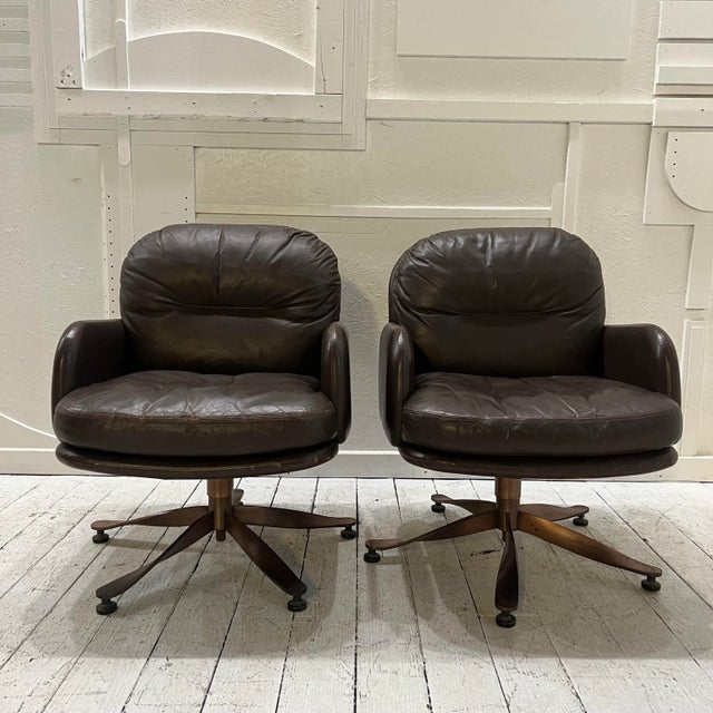 Brown leather executive office chairs with brass propeller bases. Made by Mueller furniture, original tag on bottom.