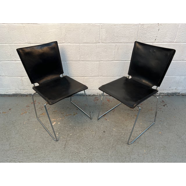 Sleek, sophisticated, and exceptionally well-crafted, these "Pelle" armless dining chairs by renowned designer Toyoda...