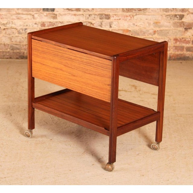 Mid Century drop leaf teak trolley, circa 1960s. Extending drop leaf top, undershelf and castors. Excellent restored...