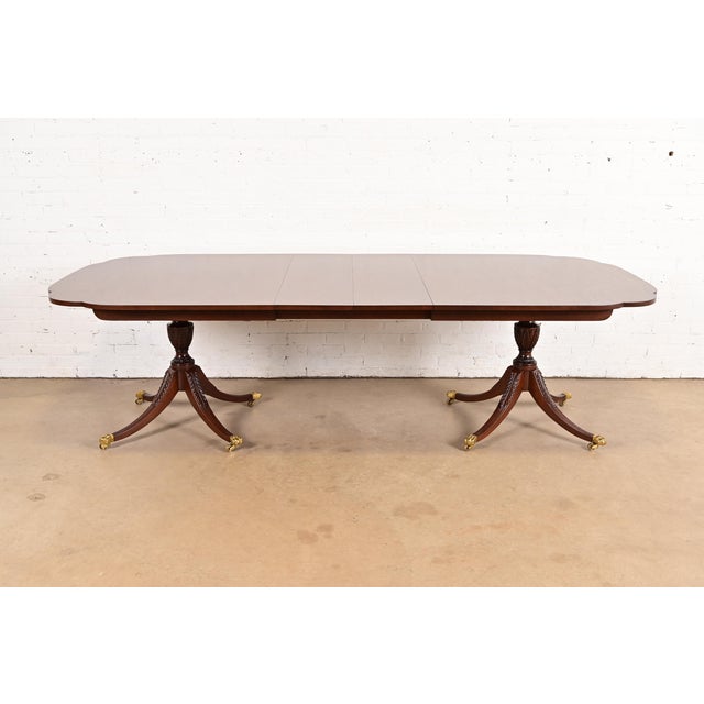 An exceptional Georgian or Regency style double pedestal extension dining table By Kindel Furniture USA, Circa 1980s...