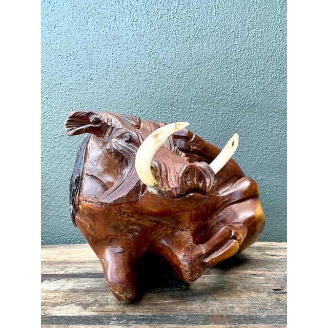 This captivating vintage hand-carved wild boar sculpture is a remarkable example of artisan craftsmanship and global folk...