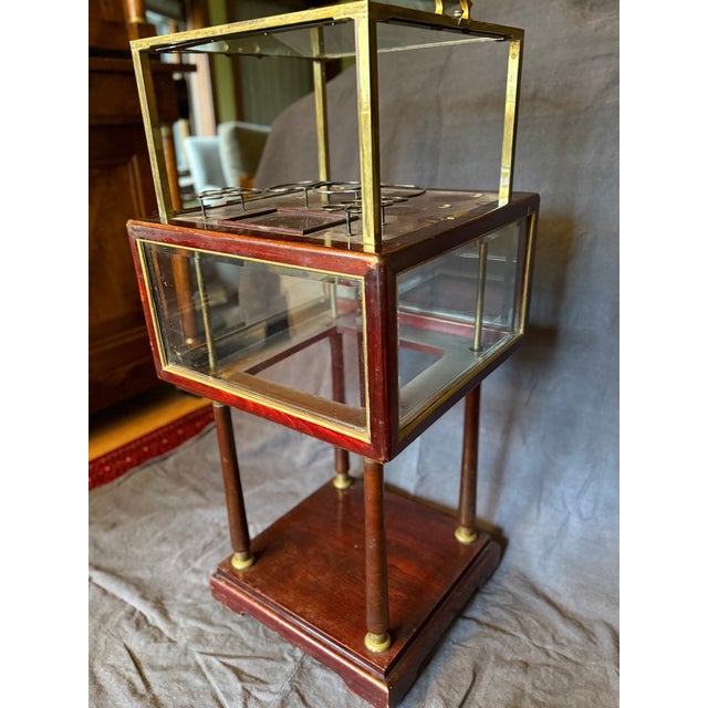 Antique mahogany and brass pop-up metamorphic bar and cigar table. All original finish and glass, including racks for 3...