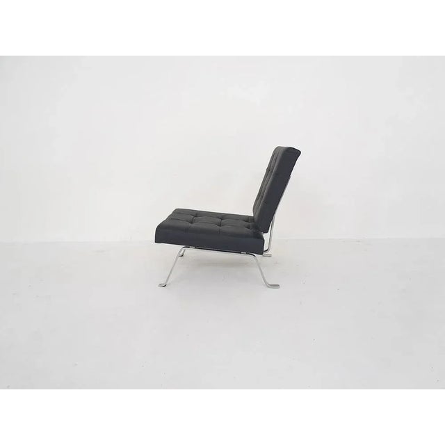 Metal frame and cushions reupholstered in black leather.AP originals was a furniture manufacturer from the Netherlands...