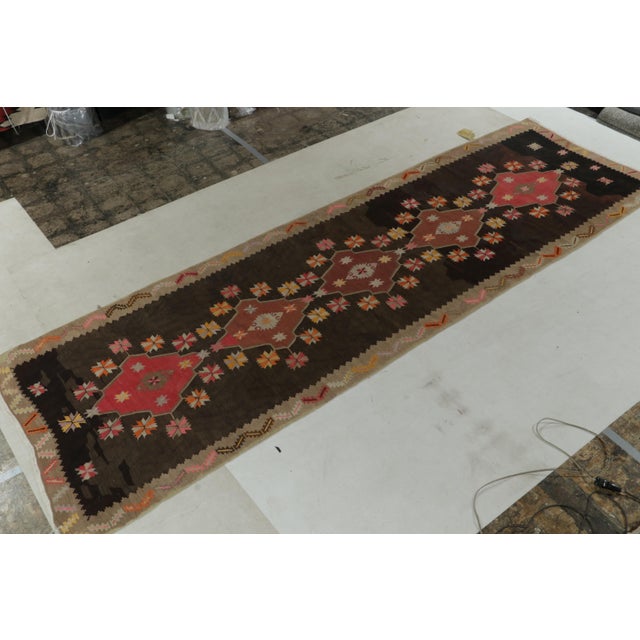 Description: Handwoven in wool, a vintage Persian Kilim rug connoting a Kurdish lineage originating circa 1950-1960...