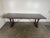 A substantial and architecturally grounded dining table executed in the Spanish Revival tradition, featuring a thick plank...