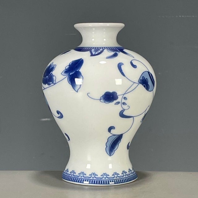 This is an elegant vintage Chinese blue and white porcelain vase , decorated in the classic qinghua palette. The vase...
