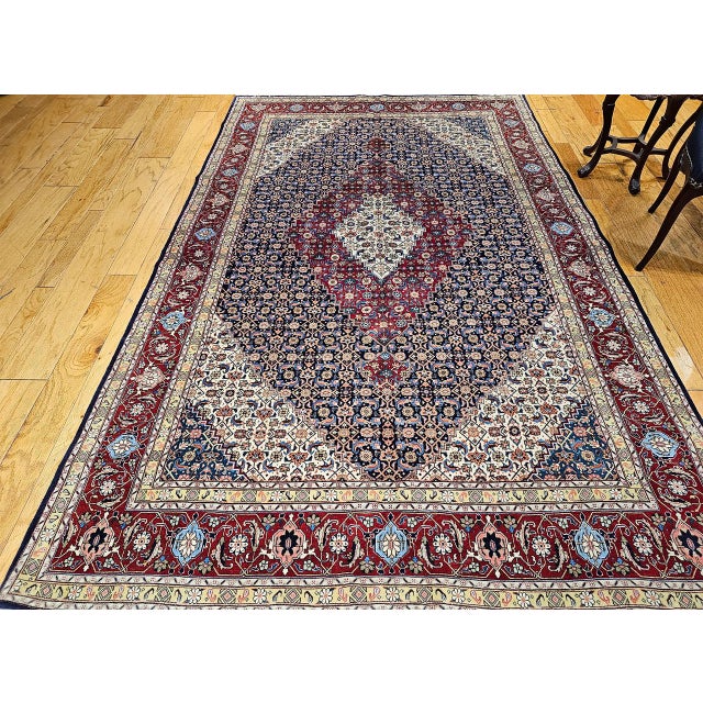 "A magnificent early 20th century Persian Tabriz Mahi room size rug hand-knotted in the classic and beloved geometric...