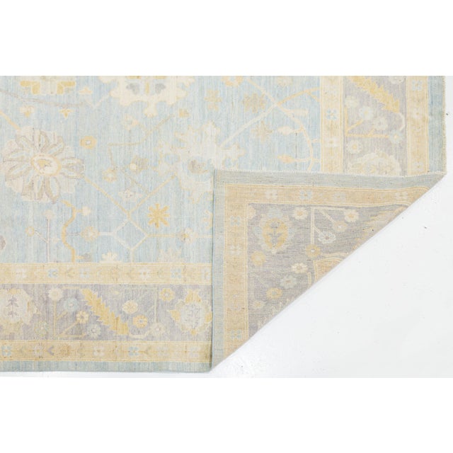 Enhance your space with the elegance of this Modern Oushak Style Wool Rug. Featuring traditional Turkish motifs in a...