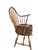 A handsome antique Windsor armchair featuring a tall, gracefully arched continuous bow-back, slender turned spindles, and...