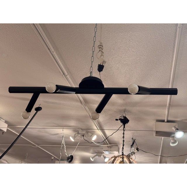Design Plus Gallery presents the Oaks Tall Wall Sconce from Avenue Lighting. This modern wall sconce has a black metal...