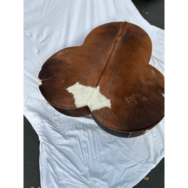 Vintage Cloverleaf Cowhide Ottoman With Brass Casters & Nailhead Trim For Sale - Image 4 of 7