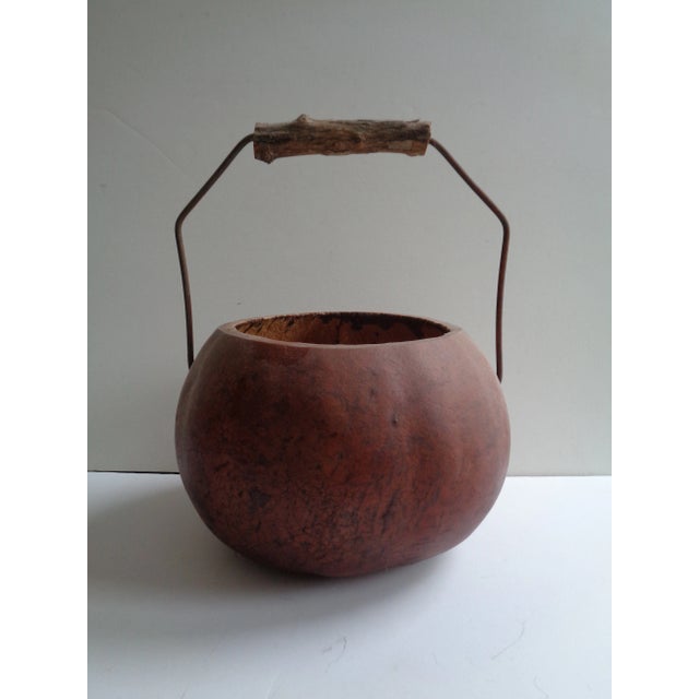 Rustic round gourd basket. Metal and bark handle. Brown. Perfect for dried flowers or as a centerpiece on your table.